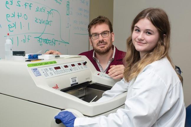 Jayden and Dr. Harrison working with lab equipment